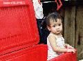 "Little Girl in the Empty Cooler",
Photographer/Artist: Nestor Santiago,
Date Taken: 2002,
Place Taken: Davao
