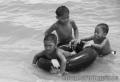 "Salbabida 2 or Kids with a Tire Interior",
Photographer/Artist: Willy Lorenzana,
Date Taken: 2005,
Place Taken: Laiya, Batangas				,
		